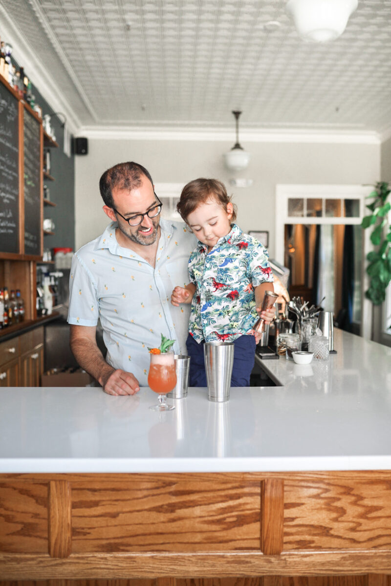 Father and son behind the bar