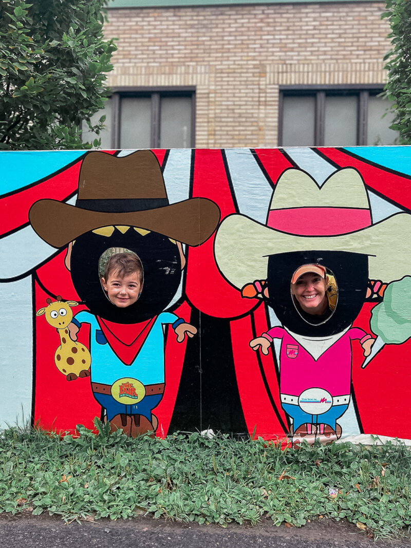 A boy mom jumping behind displays. We almost covered each one at the NYS Fair.